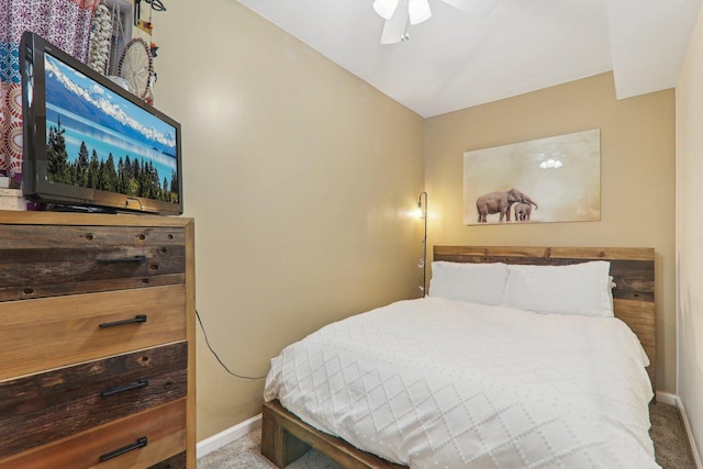 carpeted bedroom with a ceiling fan and baseboards