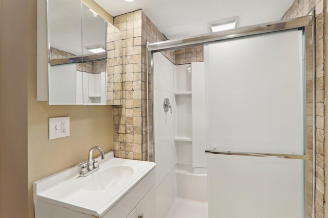 full bath featuring vanity and an enclosed shower