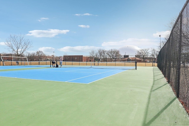 view of sport court featuring fence