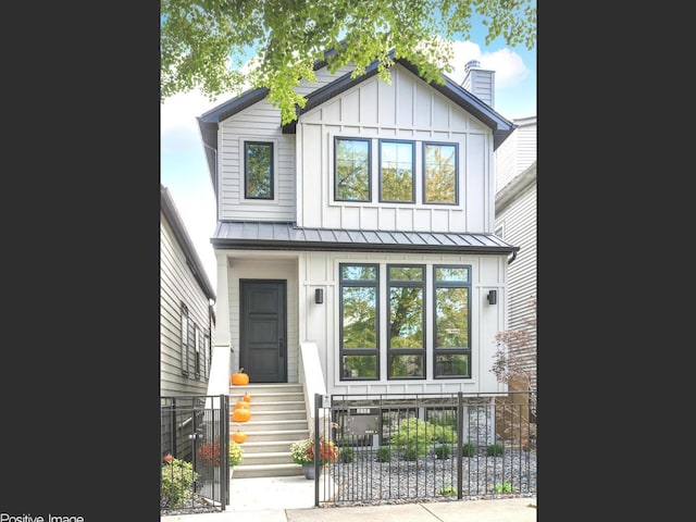 view of front facade featuring a standing seam roof, fence, board and batten siding, and entry steps