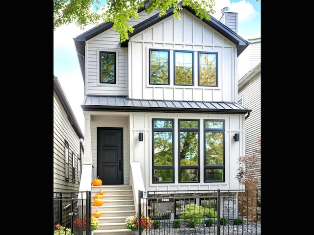 1741 N Rockwell St, Chicago, IL 60647 - modern farmhouse with a standing seam roof, fence, board and batten siding, metal roof, and entry steps