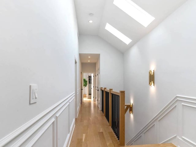 1741 N Rockwell St, Chicago, IL 60647 - corridor with light wood-type flooring, an upstairs landing, lofted ceiling with skylight, and a decorative wall