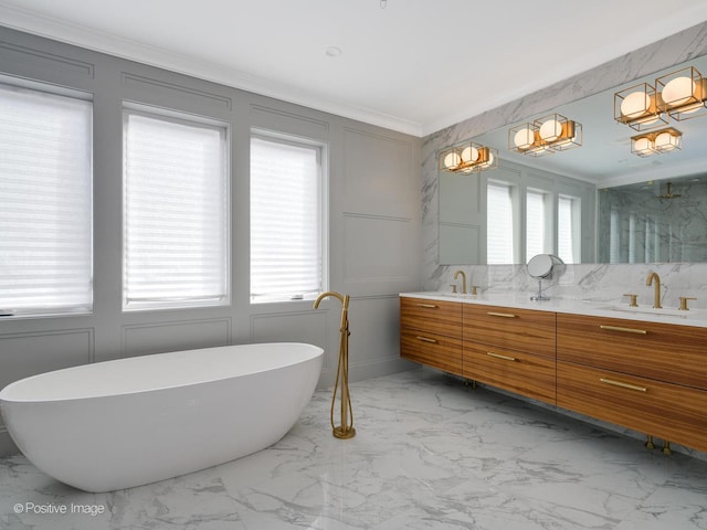 bathroom featuring a sink, plenty of natural light, marble finish floor, and a decorative wall