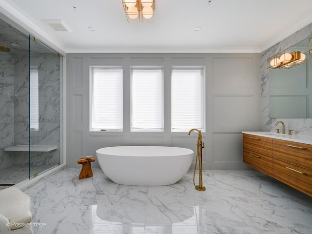 bathroom with a wealth of natural light, a decorative wall, marble finish floor, and ornamental molding