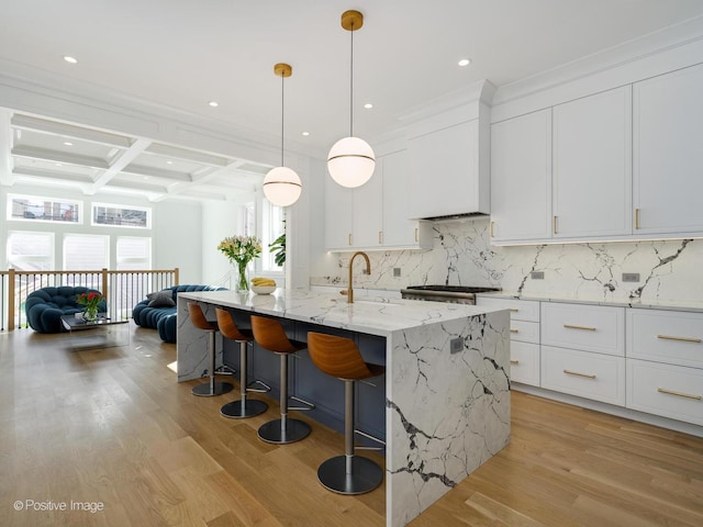 kitchen featuring decorative backsplash, coffered ceiling, white cabinets, and light wood finished floors