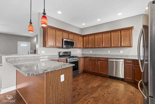 kitchen featuring brown cabinets, a peninsula, and stainless steel appliances