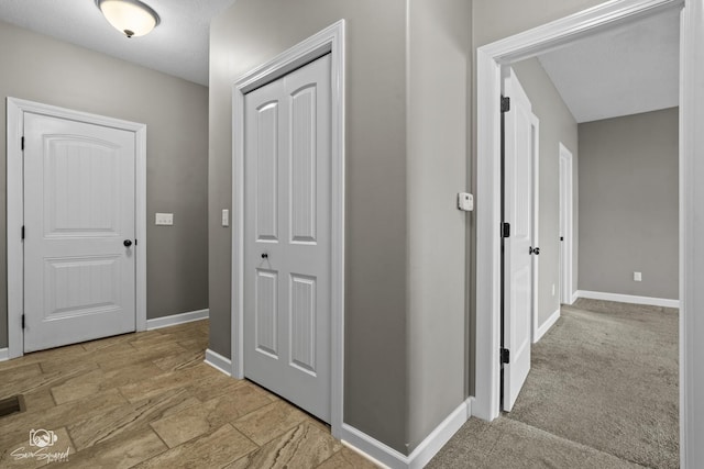 corridor featuring baseboards