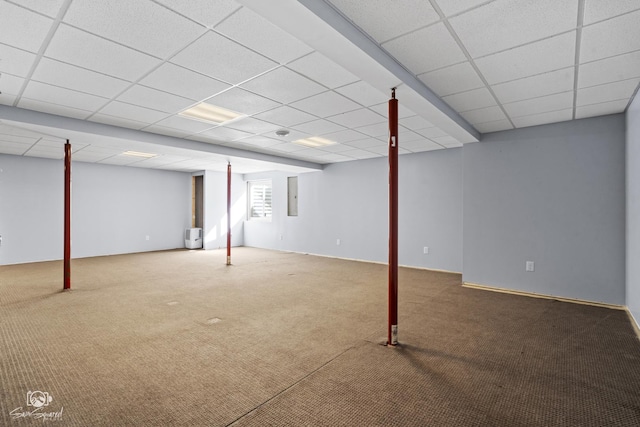 below grade area featuring a drop ceiling and carpet