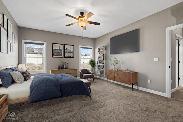 bedroom with multiple windows, carpet flooring, baseboards, and ceiling fan