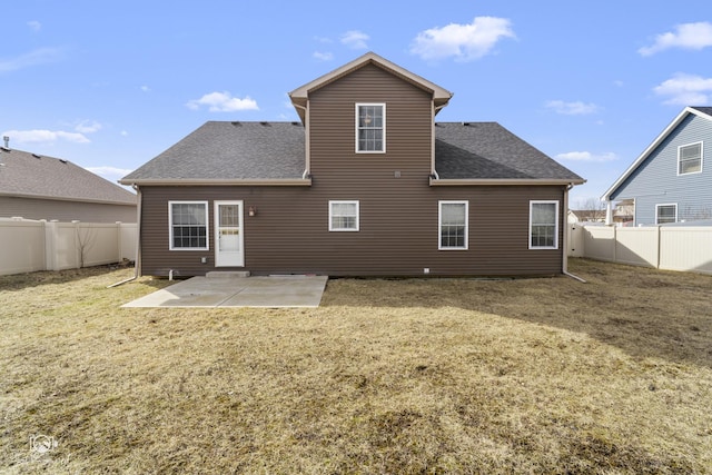 rear view of house featuring a fenced backyard, a patio, and roof with shingles