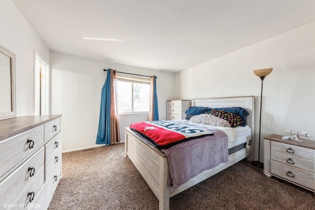 bedroom featuring dark carpet