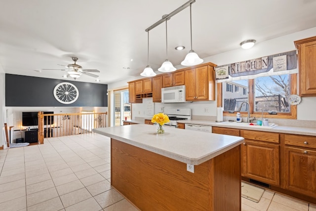 kitchen with a sink, white appliances, light tile patterned floors, and light countertops