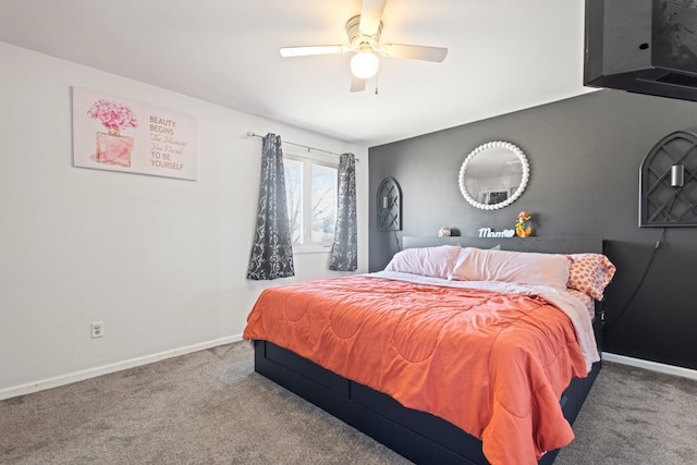 carpeted bedroom featuring baseboards and a ceiling fan