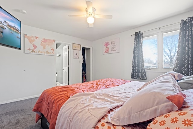 carpeted bedroom with ceiling fan and baseboards