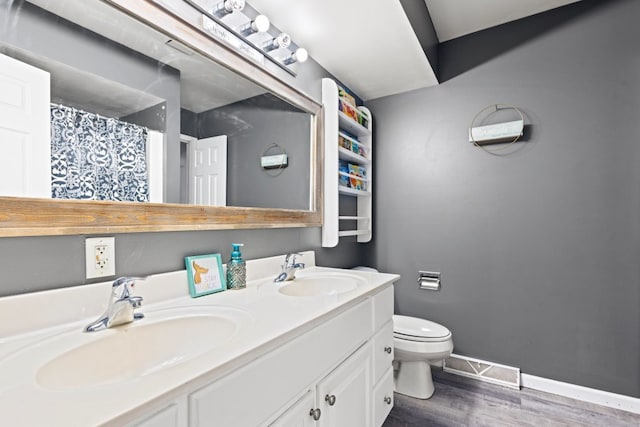 full bathroom featuring visible vents, toilet, baseboards, and a sink