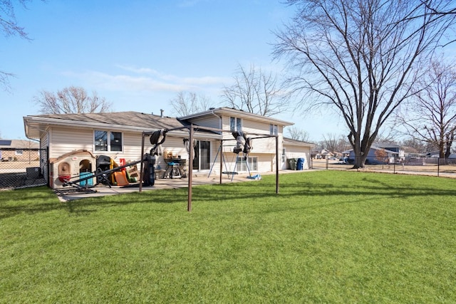 back of house featuring a patio area, a garage, a lawn, and fence