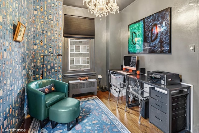 office area featuring a chandelier, radiator, and wood finished floors