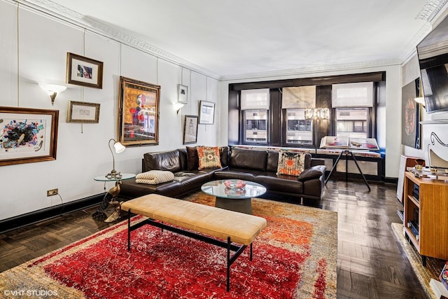 living area with baseboards and ornamental molding