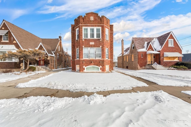 townhome / multi-family property featuring brick siding