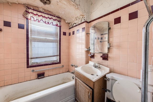 full bath featuring a bathing tub, toilet, tile walls, and vanity