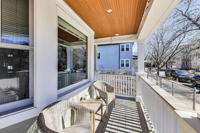 balcony with covered porch and a sunroom