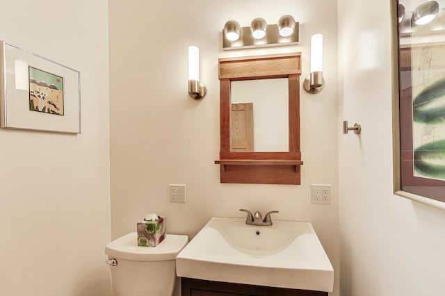 half bathroom with toilet and vanity