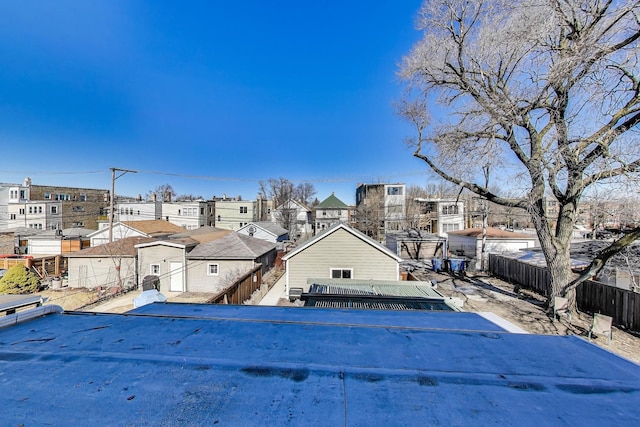 exterior space featuring a residential view and fence