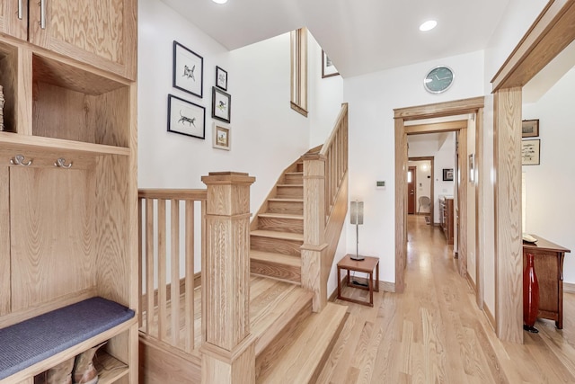 mudroom with light wood finished floors and recessed lighting