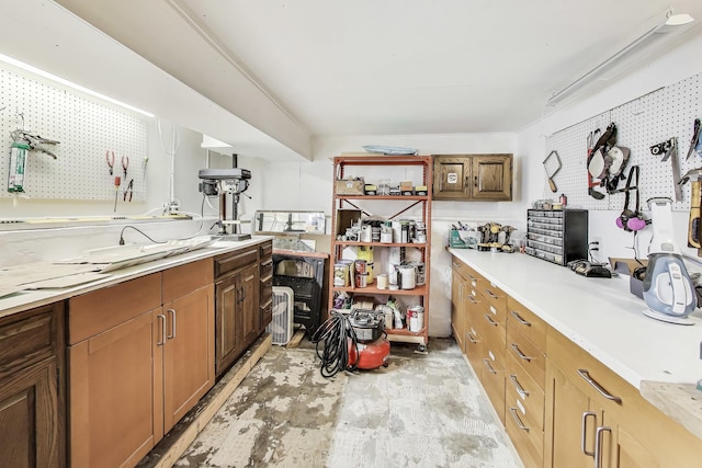 kitchen with open shelves, brown cabinetry, and light countertops