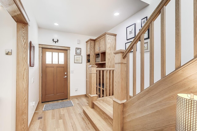 foyer entrance featuring stairs, recessed lighting, visible vents, and light wood finished floors