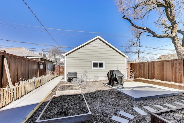 exterior space featuring a vegetable garden and a fenced backyard