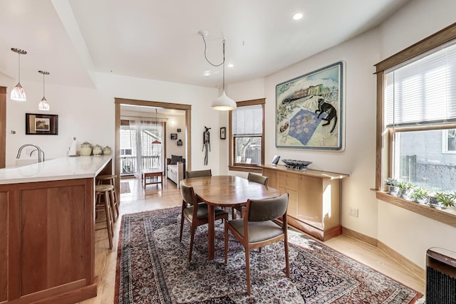 dining space with recessed lighting and baseboards