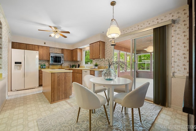 1408 N W St, Naperville, IL 60563 - dining space with wallpapered walls, light floors, baseboards, and a ceiling fan