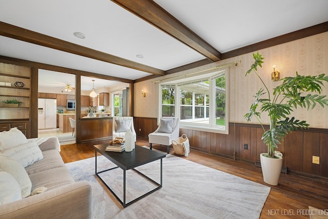 1408 N W St, Naperville, IL 60563 - living room featuring wood finished floors, a ceiling fan, wallpapered walls, beam ceiling, and wainscoting