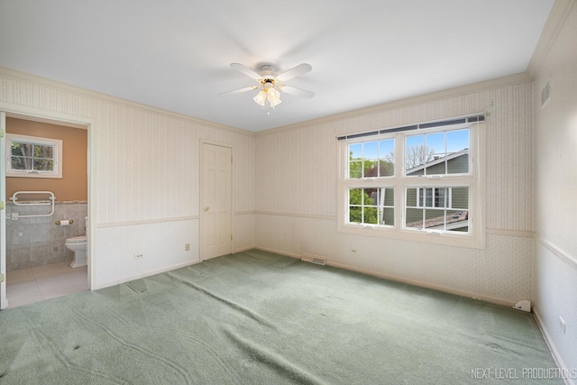 1408 N W St, Naperville, IL 60563 - unfurnished bedroom featuring ensuite bath, visible vents, crown molding, carpet flooring, and wallpapered walls