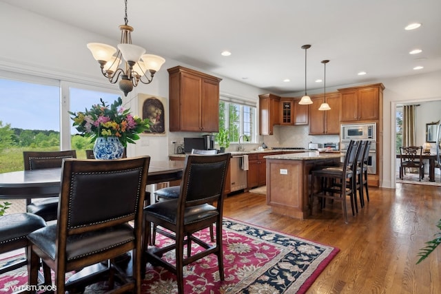 dining space featuring recessed lighting, a chandelier, and dark wood finished floors