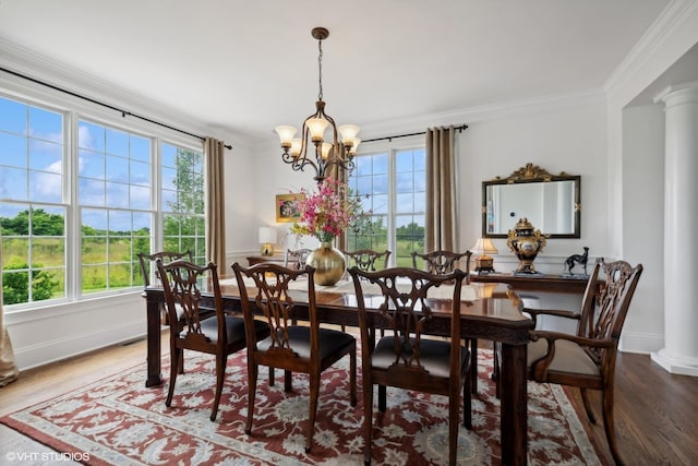 dining room featuring a wealth of natural light, ornate columns, and ornamental molding