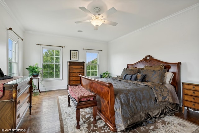 bedroom with ceiling fan, baseboards, wood finished floors, and ornamental molding