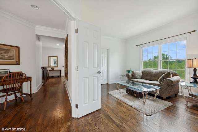 living room featuring dark wood-type flooring, baseboards, and ornamental molding