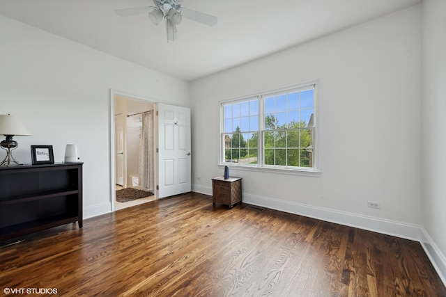 bedroom with visible vents, connected bathroom, ceiling fan, baseboards, and wood finished floors