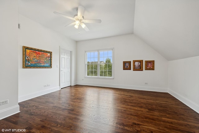 additional living space featuring visible vents, baseboards, dark wood finished floors, lofted ceiling, and ceiling fan