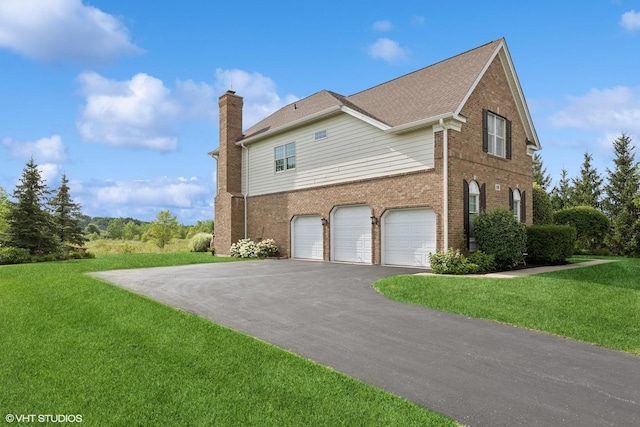 view of property exterior with brick siding, a chimney, driveway, a yard, and an attached garage