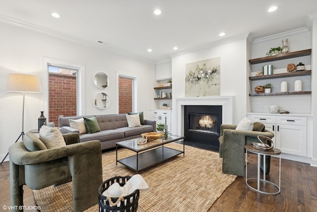 living room featuring visible vents, a fireplace with flush hearth, ornamental molding, and dark wood-style flooring