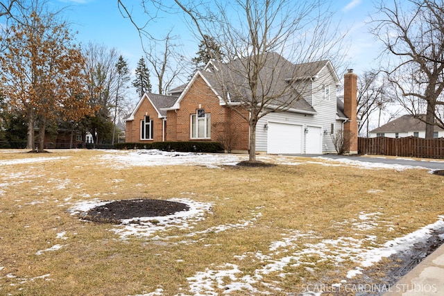 traditional home featuring a garage, fence, brick siding, and driveway