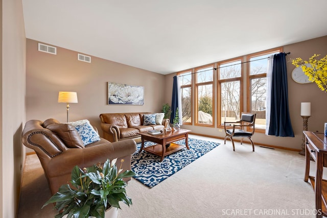 carpeted living room with visible vents and baseboards