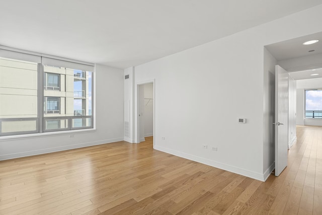 empty room with light wood-style floors and baseboards