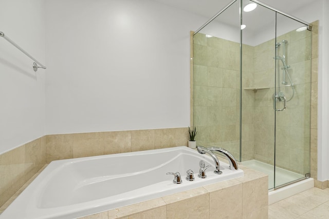 full bath featuring tile patterned flooring, a shower stall, and a garden tub