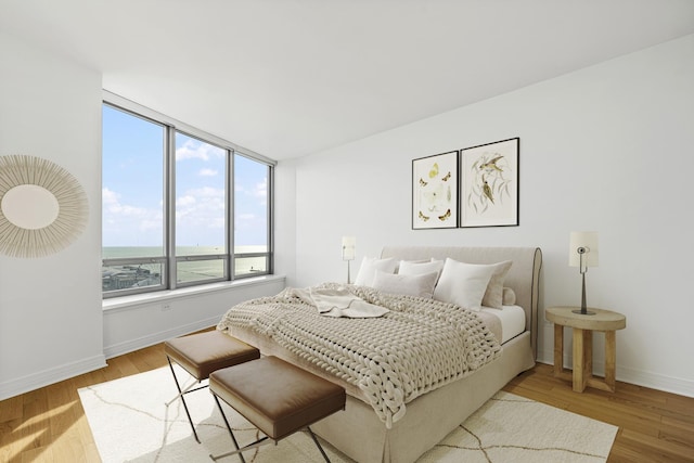 bedroom featuring light wood-type flooring and baseboards