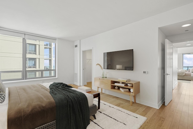 bedroom featuring baseboards and light wood-type flooring