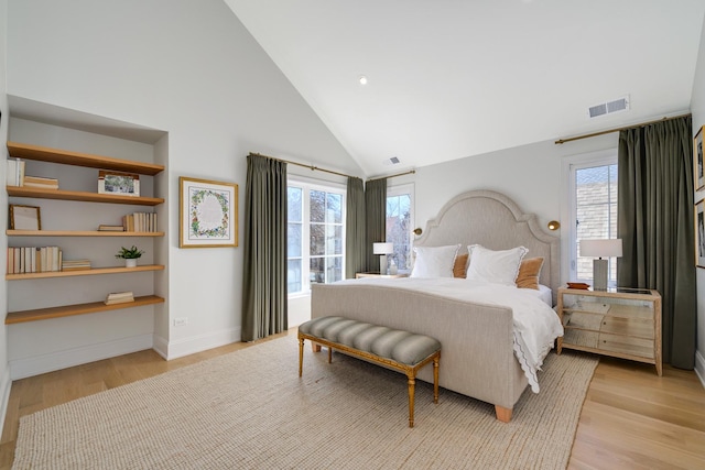 bedroom featuring light wood-style flooring, multiple windows, and visible vents